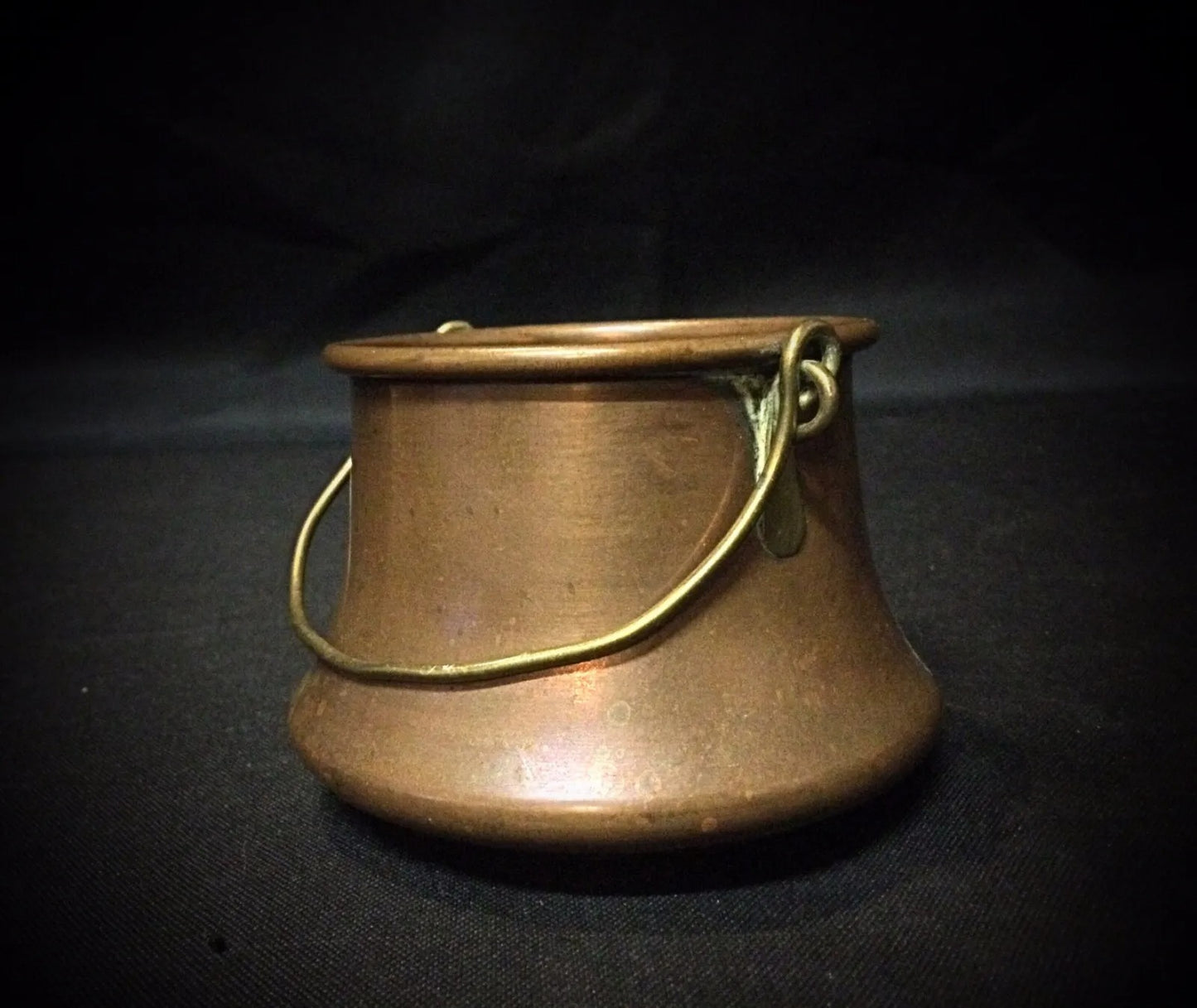 Side view of the antique copper cauldron with detailed 'Poitiers' engraving.