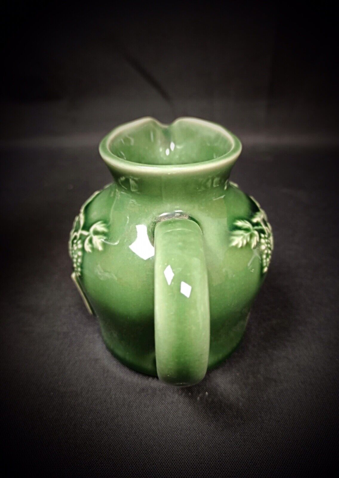 Side view of vintage porcelain grape motif jug