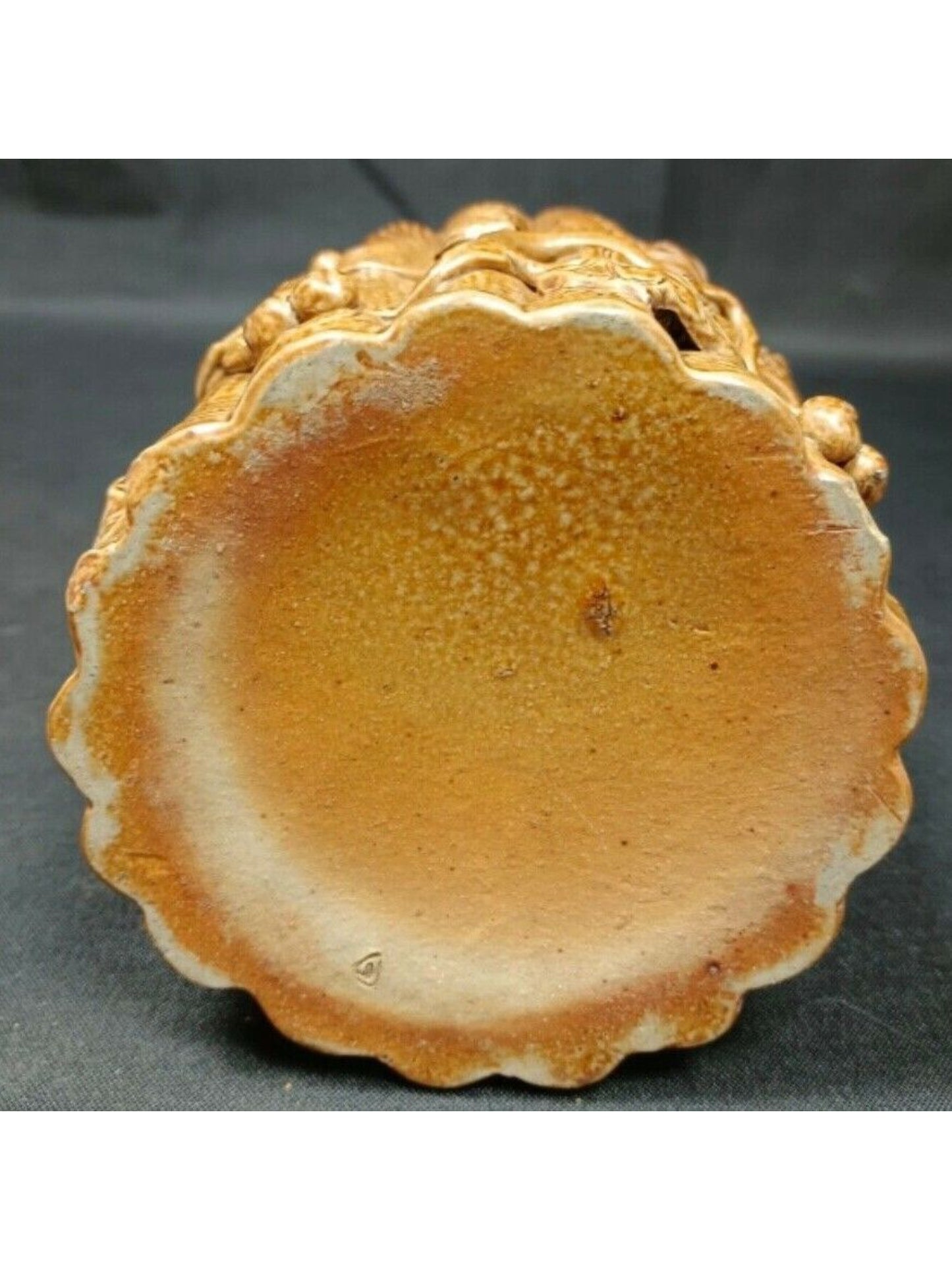 Side view of carved terra cotta flower pot