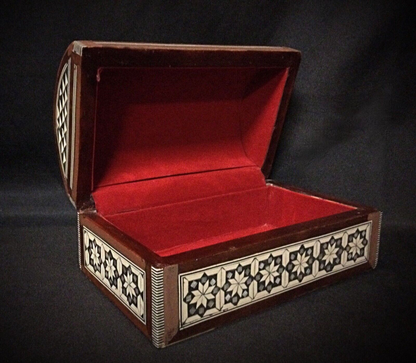 Side view of the antique Syrian wood jewelry box with intricate mother-of-pearl design.