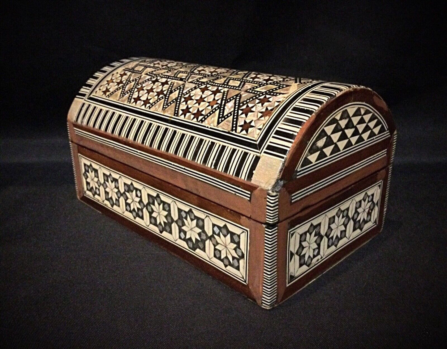 Open view of the jewelry box, showcasing the rich red velvet interior.