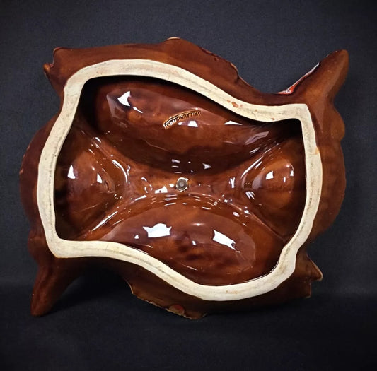 Close-up detail of the rooster-shaped handle sculpture