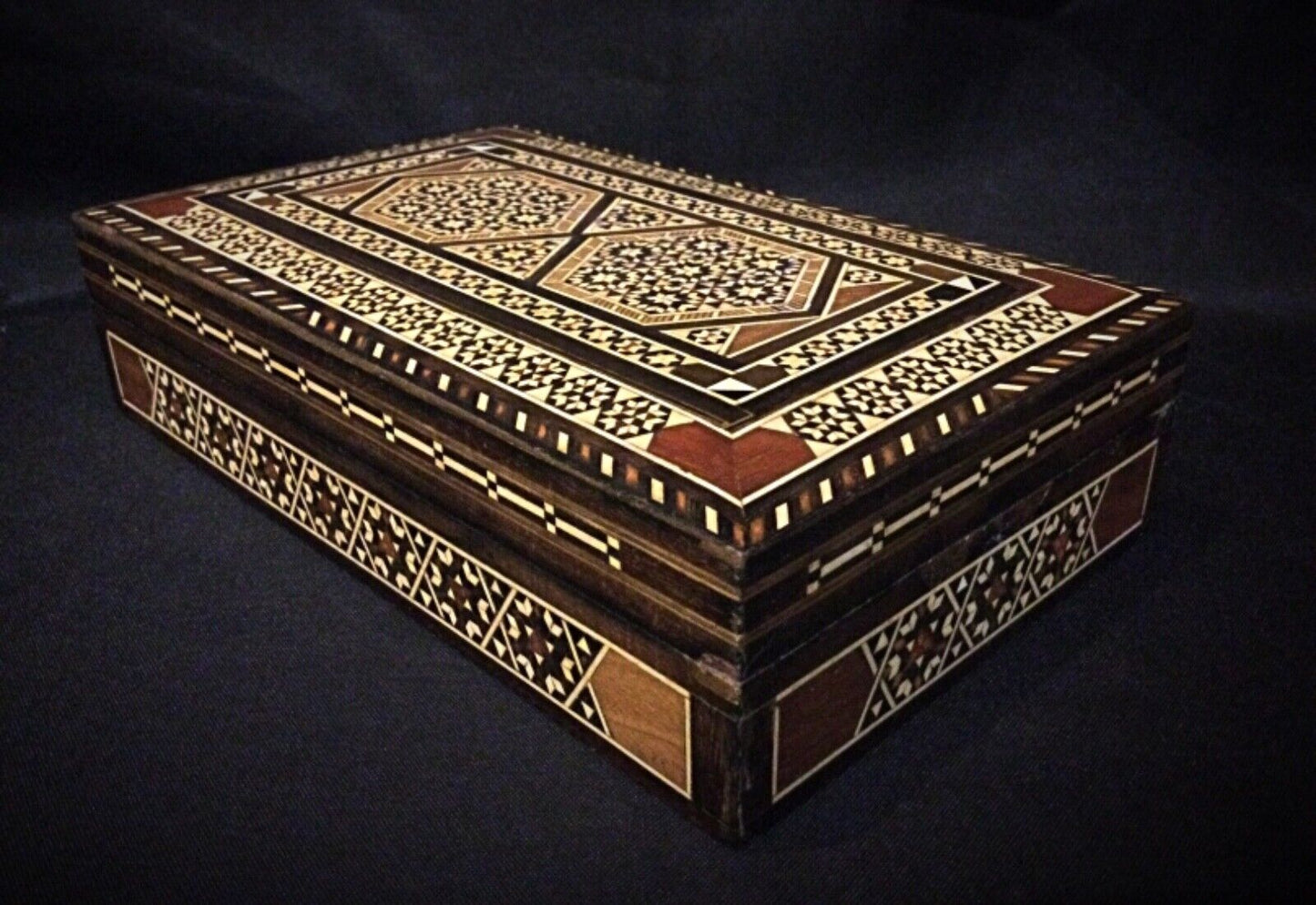 Side view showing minor scuffs on the edges of the wooden box.
