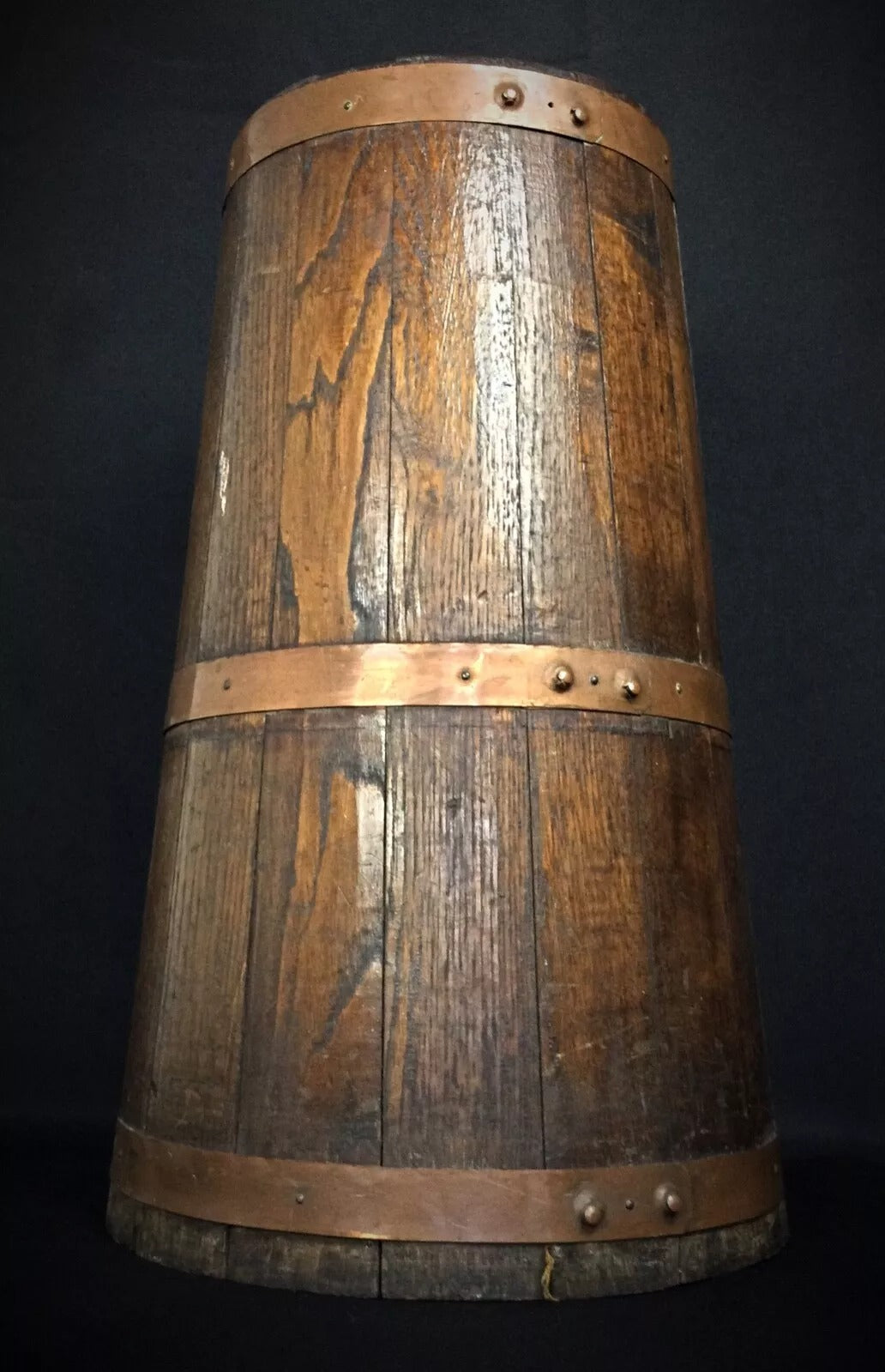 Beautifully crafted wooden butter churn secured with copper bands in traditional French farmhouse style