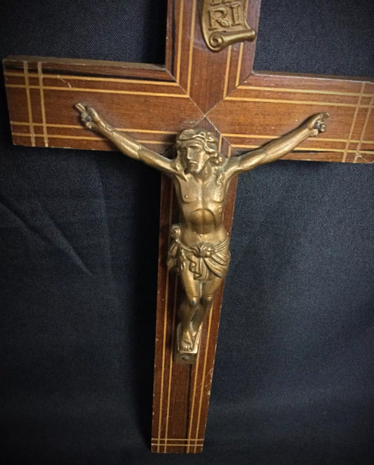 Vintage Christian religious crucifix with metal figure on wooden cross ideal for devotional or decorative display