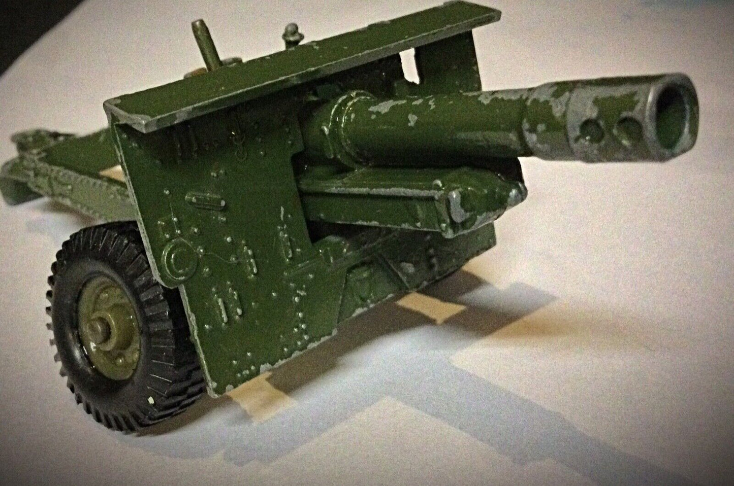 The miniature cannon with rotating wheels, showcasing detailed craftsmanship