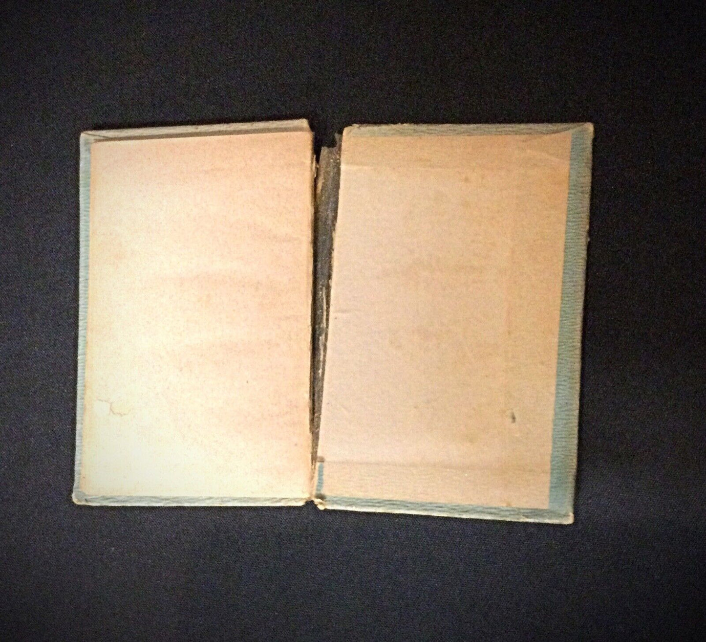 Image of the vintage books stacked on a shelf, emphasizing their historical value
