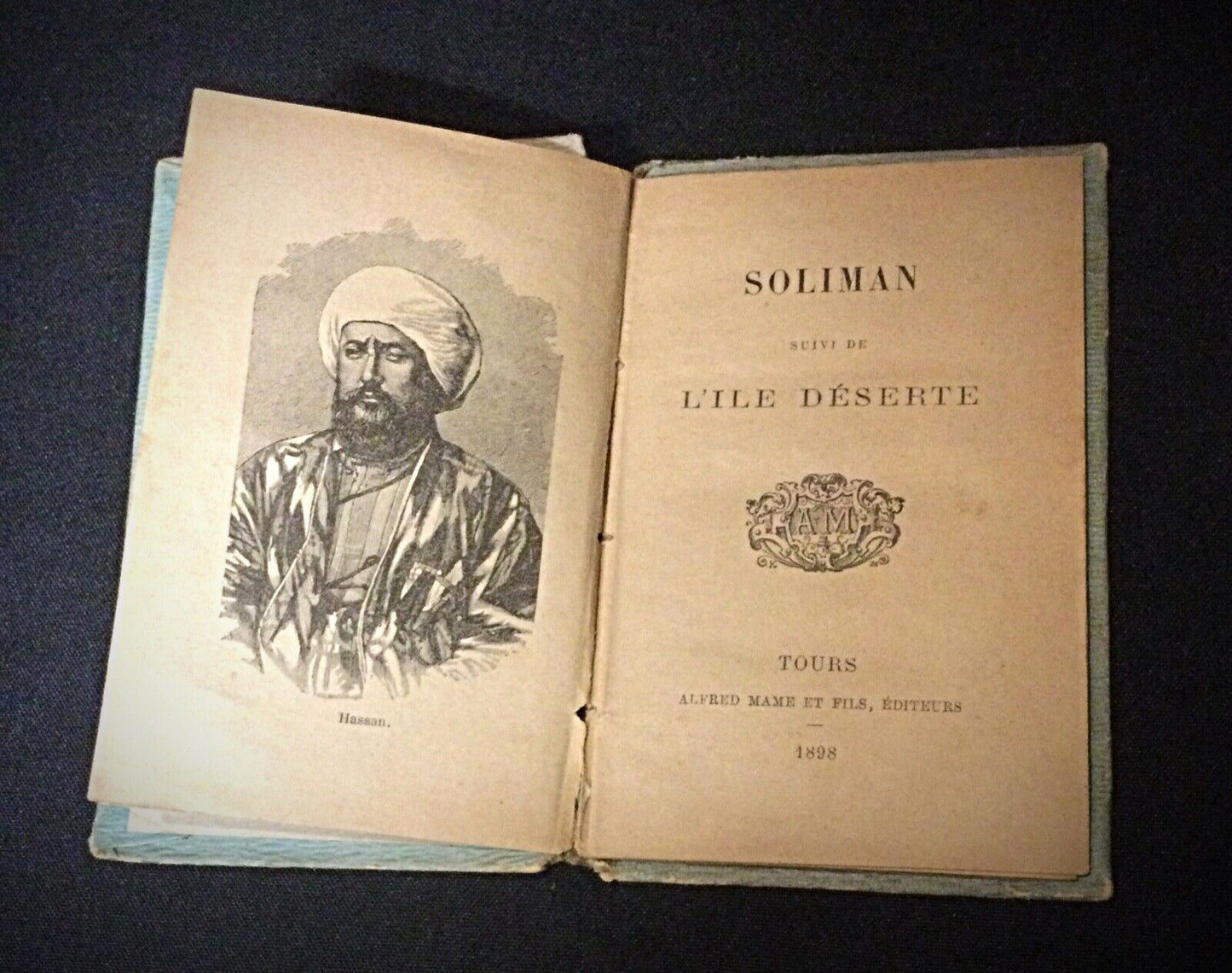 Close-up of the spine of each book, showcasing the age and wear