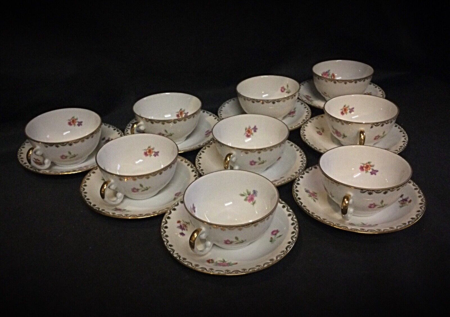 Close-up of gold-trimmed French porcelain coffee cup with floral design