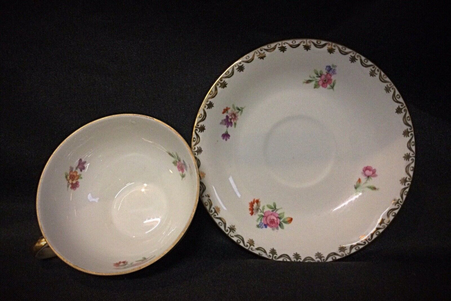 Top-down view of the vintage porcelain saucers with gold-rimmed edges