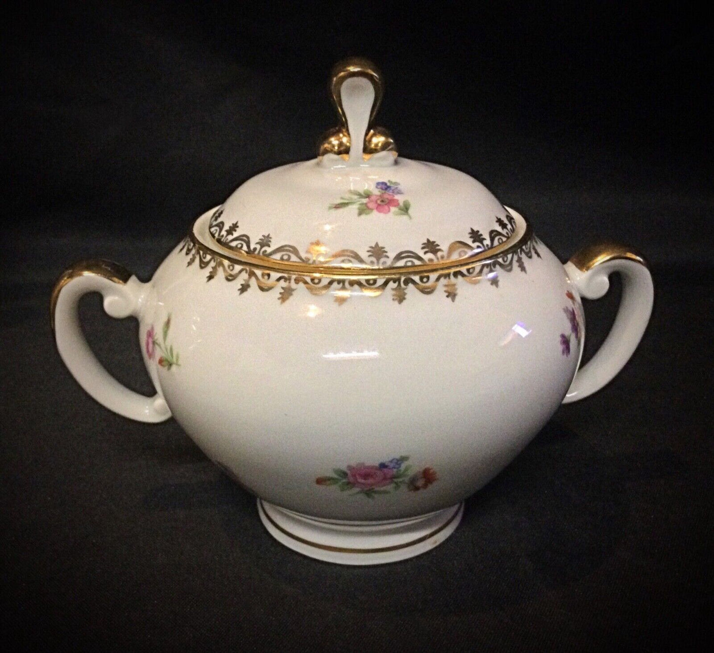Classic French porcelain coffee service set displayed on a wooden table
