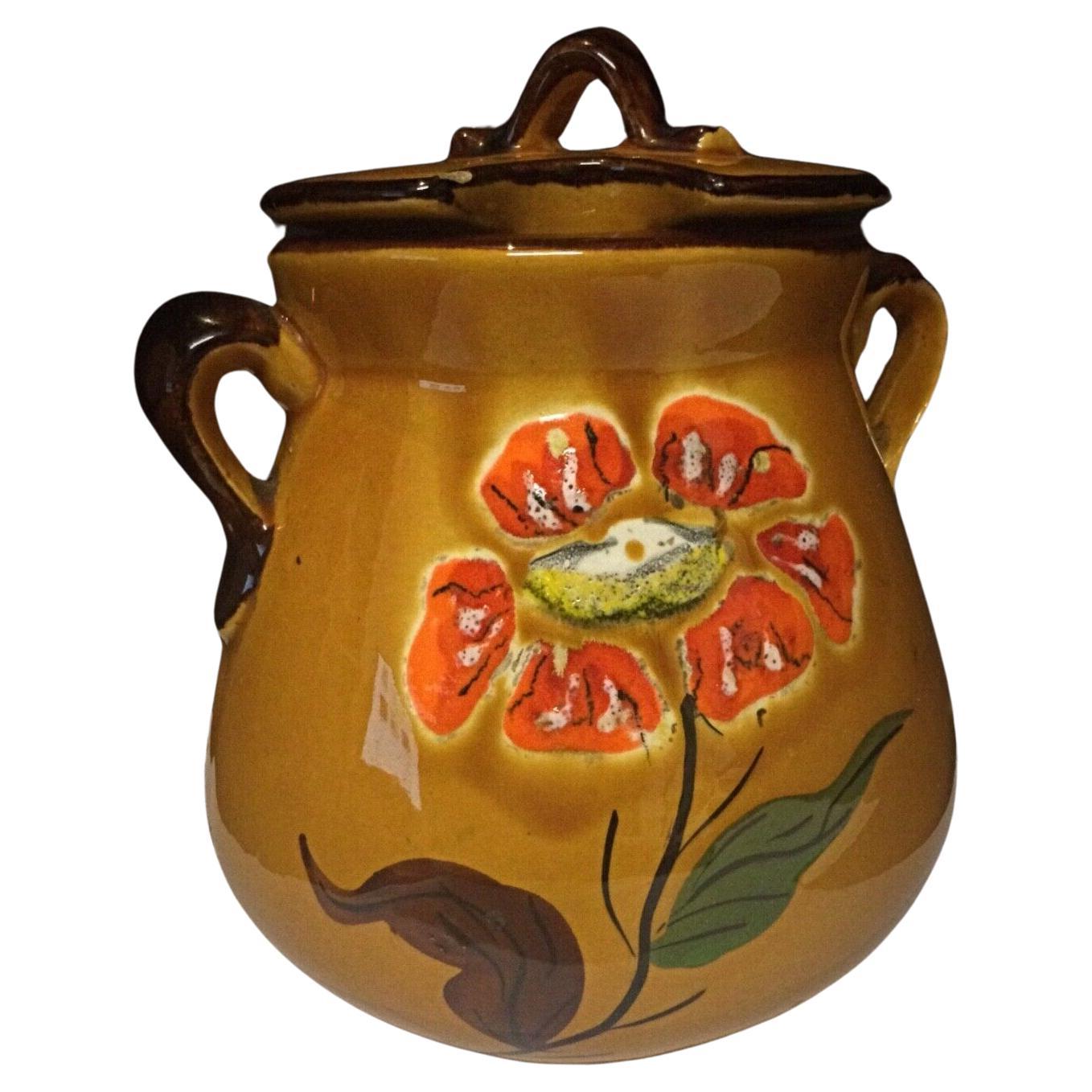 Antique faience pot with handle and floral decoration