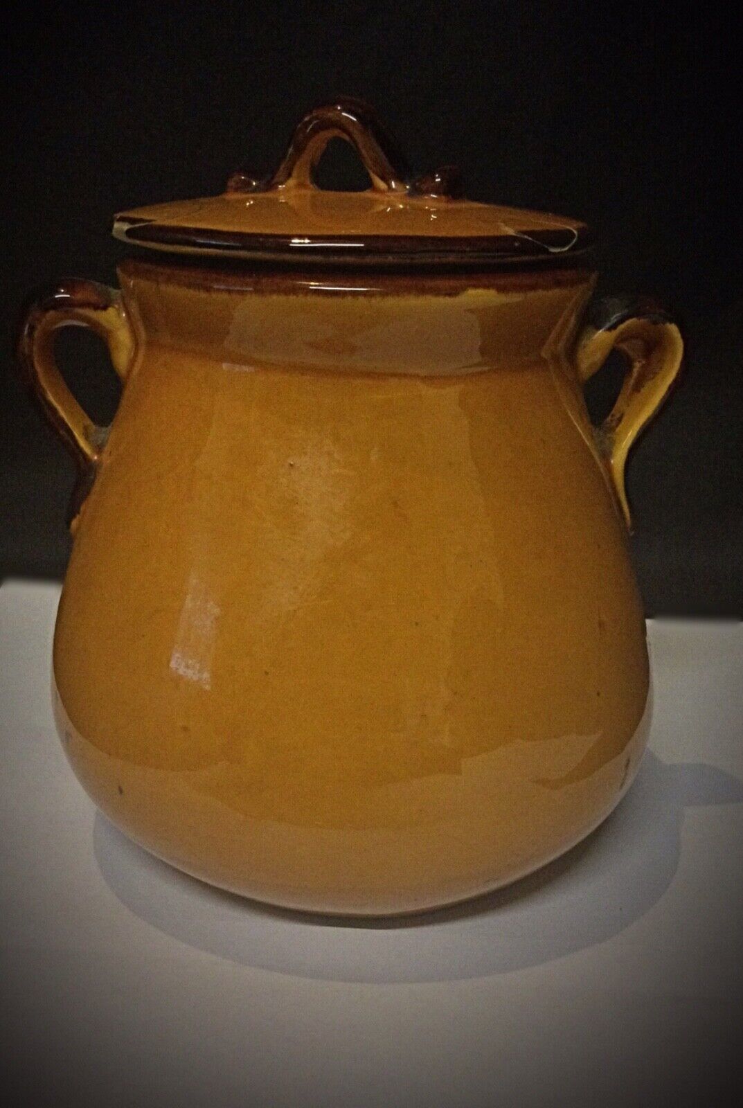 Antique ceramic jar with aged patina and painted flowers