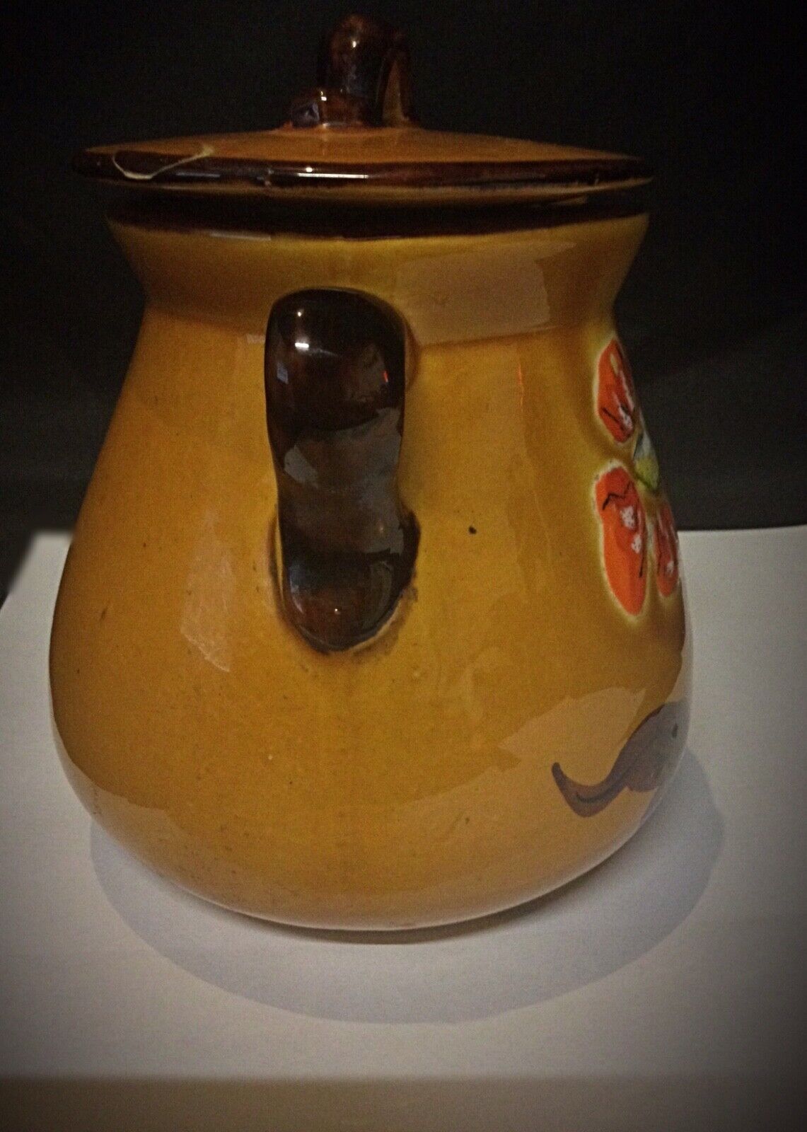 Side view of vintage faience pot with sturdy handle