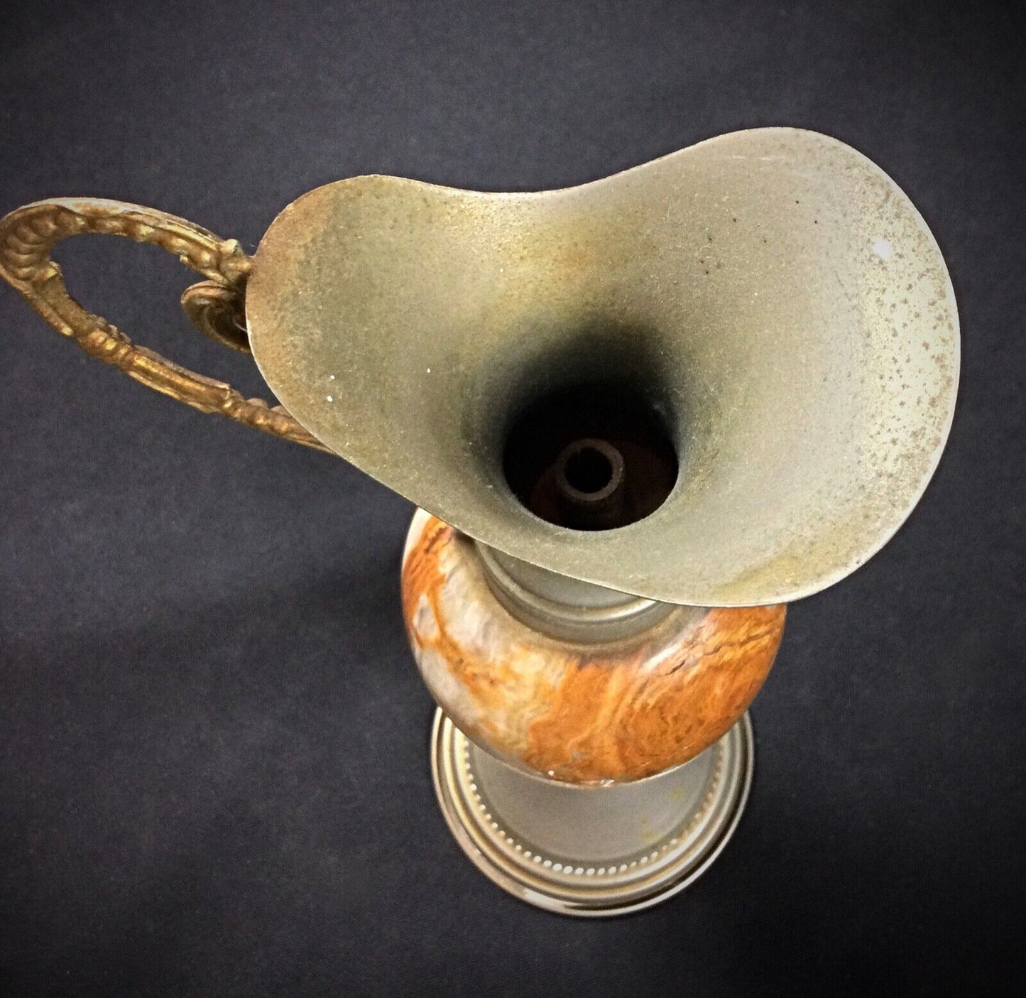 Side angle of a vintage onyx vase with pewter embellishments