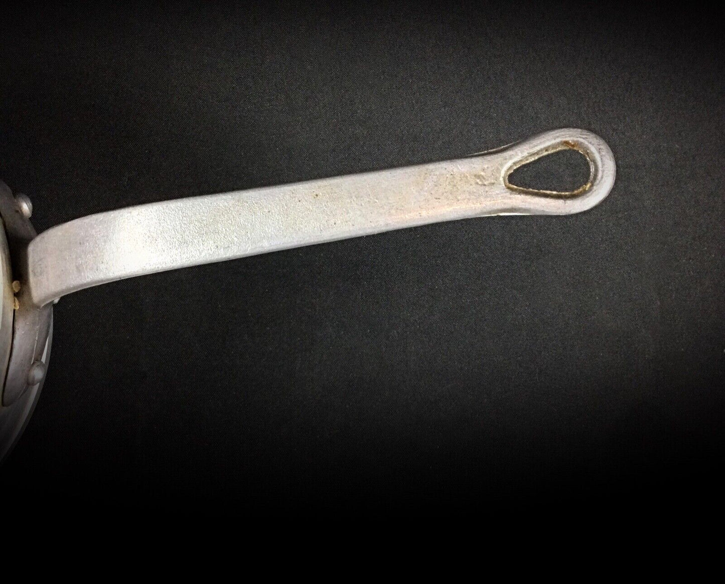 Side angle of the saucepan showing its classic French design