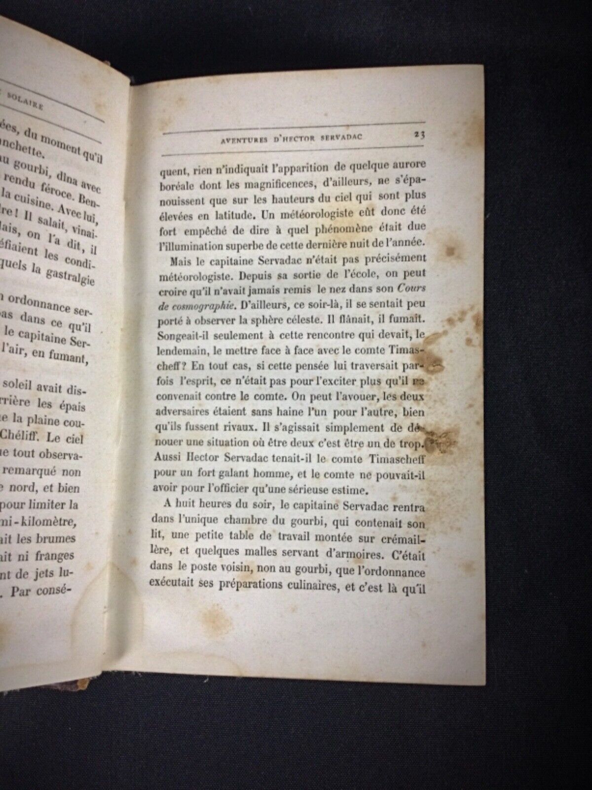 Close-up of spine showing slight wear on vintage Jules Verne book