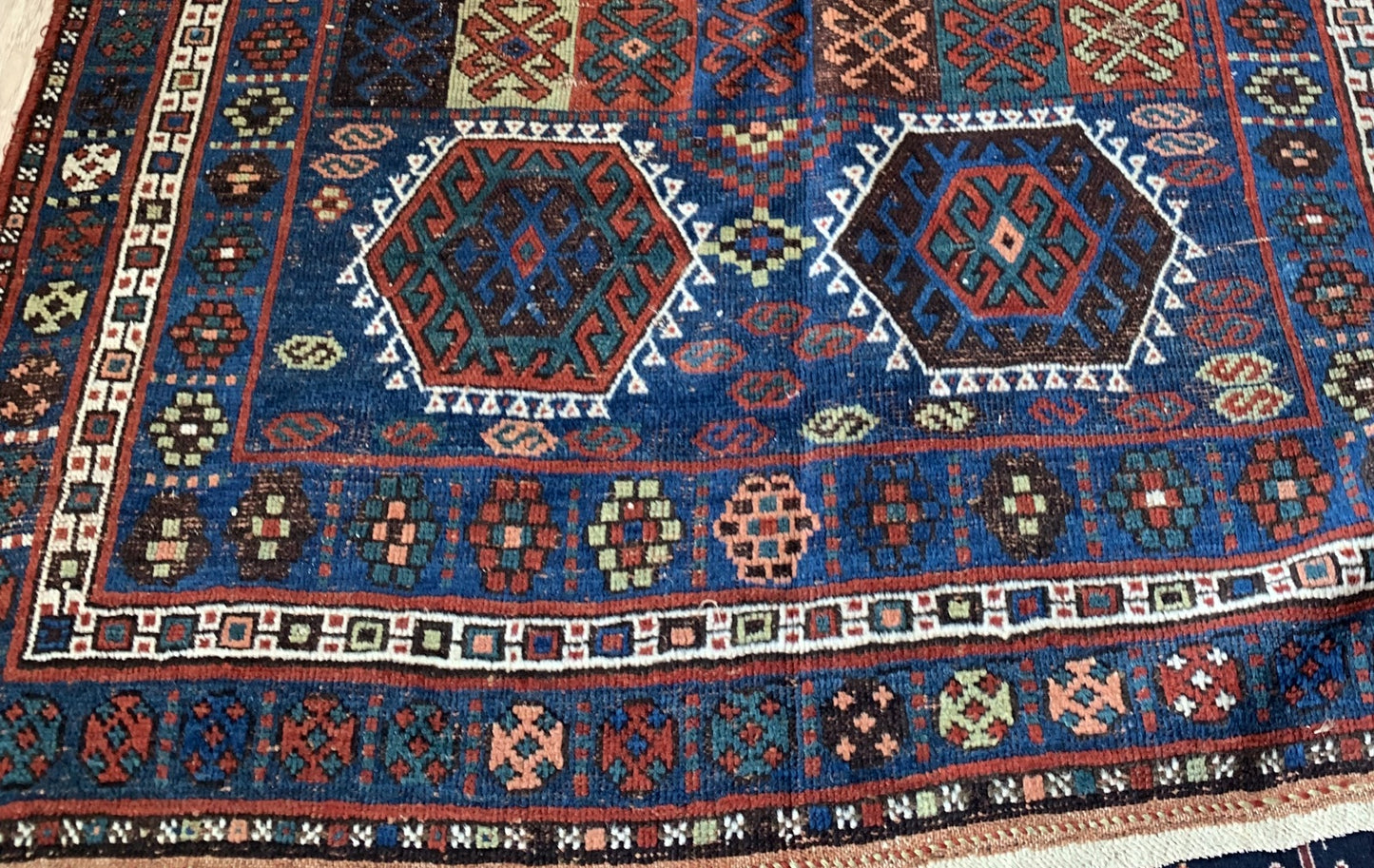 Hand-knotted wool texture on antique rug from 1880s