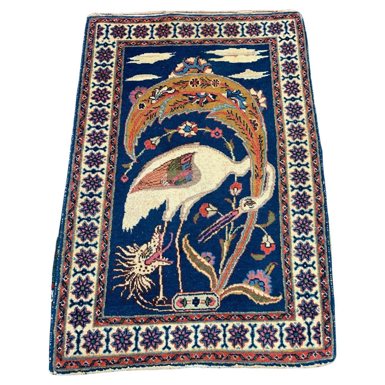 antique Persian Tabriz rug with mythical bird and dragon