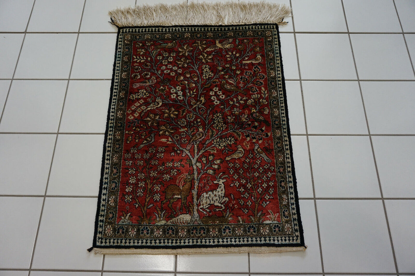 Close-up of the rich symbolism and storytelling elements on the rug