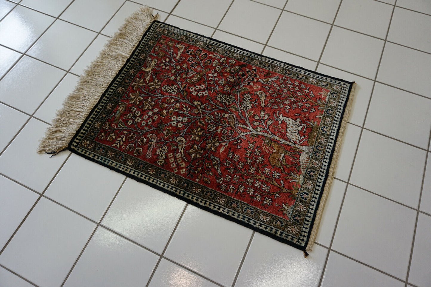Angled shot of the Persian Qum silk rug adding sophistication to a study area