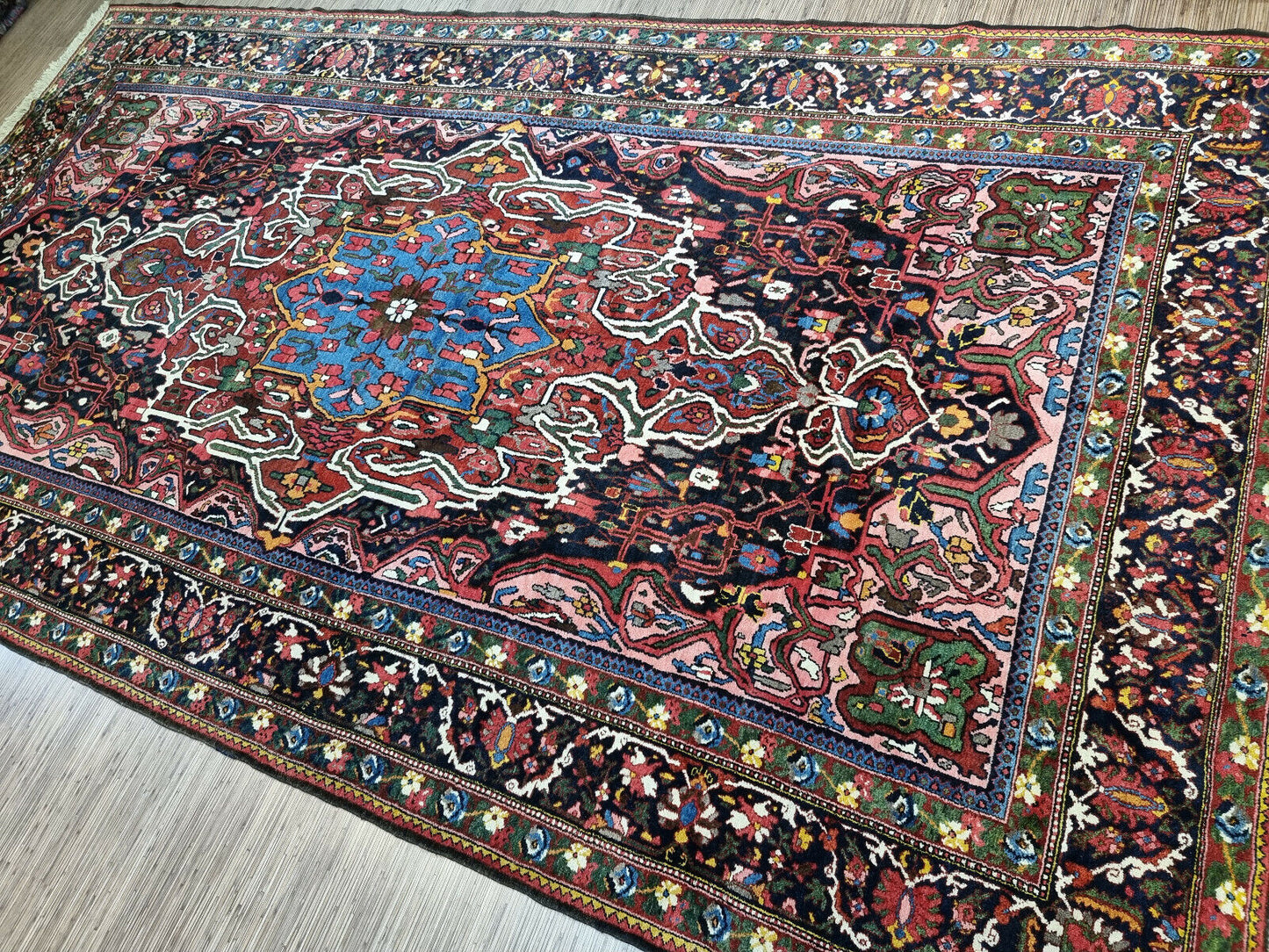 Close-up of historical significance on Handmade Antique Persian Bakhtiari Rug - Detailed view emphasizing the historical significance and cultural value of owning an antique Persian rug.