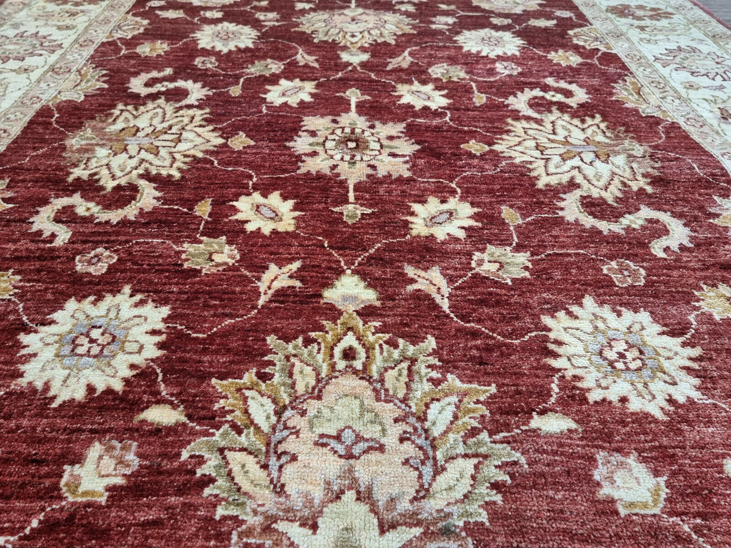Close-up of rich red central field on Handmade Vintage Afghan Zigler Rug - Detailed view highlighting the rich red color of the central field.