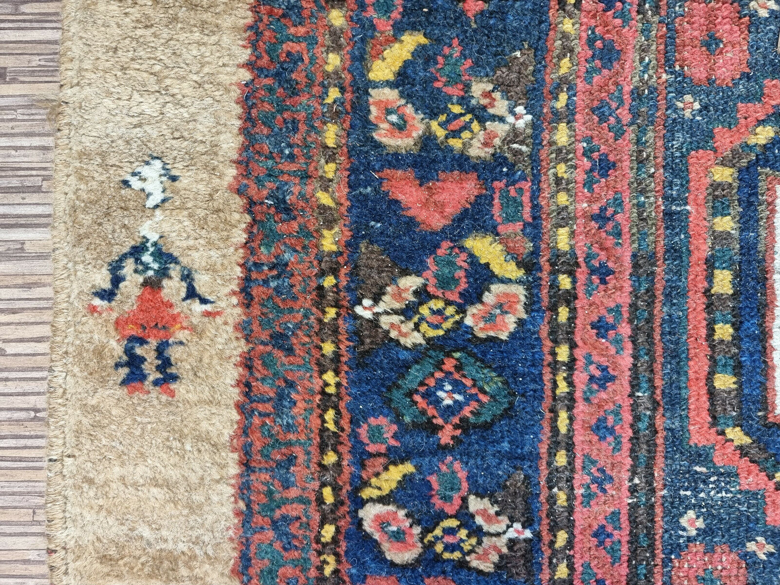 Close-up of vibrant green accents on Handmade Antique Persian Camel Hair Runner Rug - Detailed view highlighting the vibrant green accents interspersed within the floral motifs on the border.