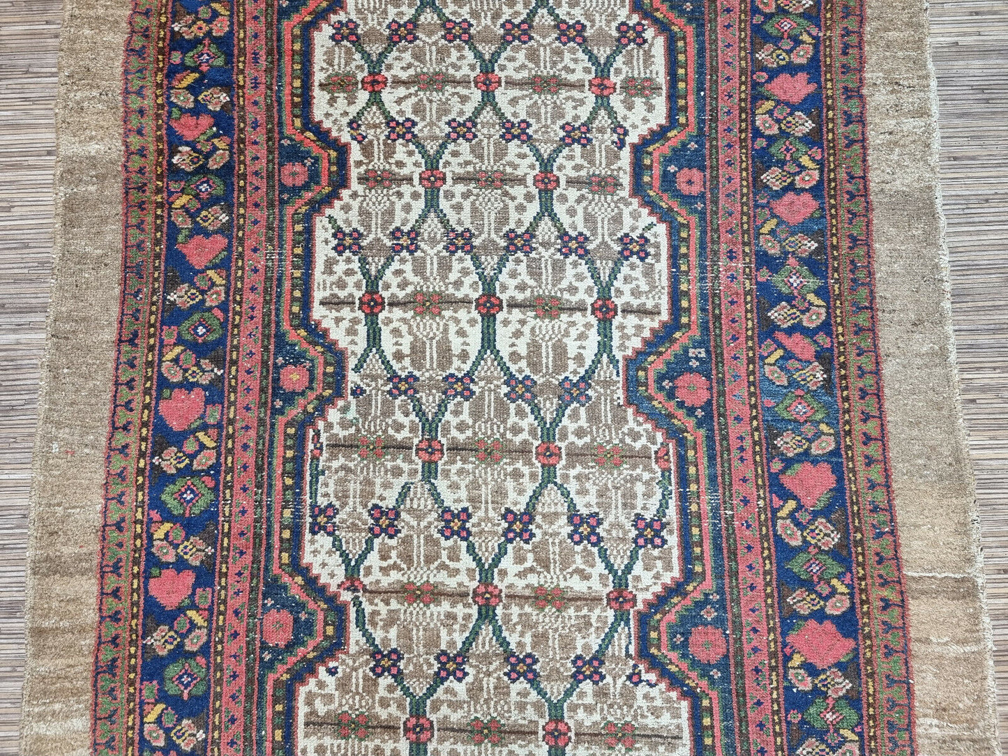 Close-up of symmetrical balance on Handmade Antique Persian Camel Hair Runner Rug - Detailed view emphasizing the symmetrical balance achieved by the geometric shapes in the central field.