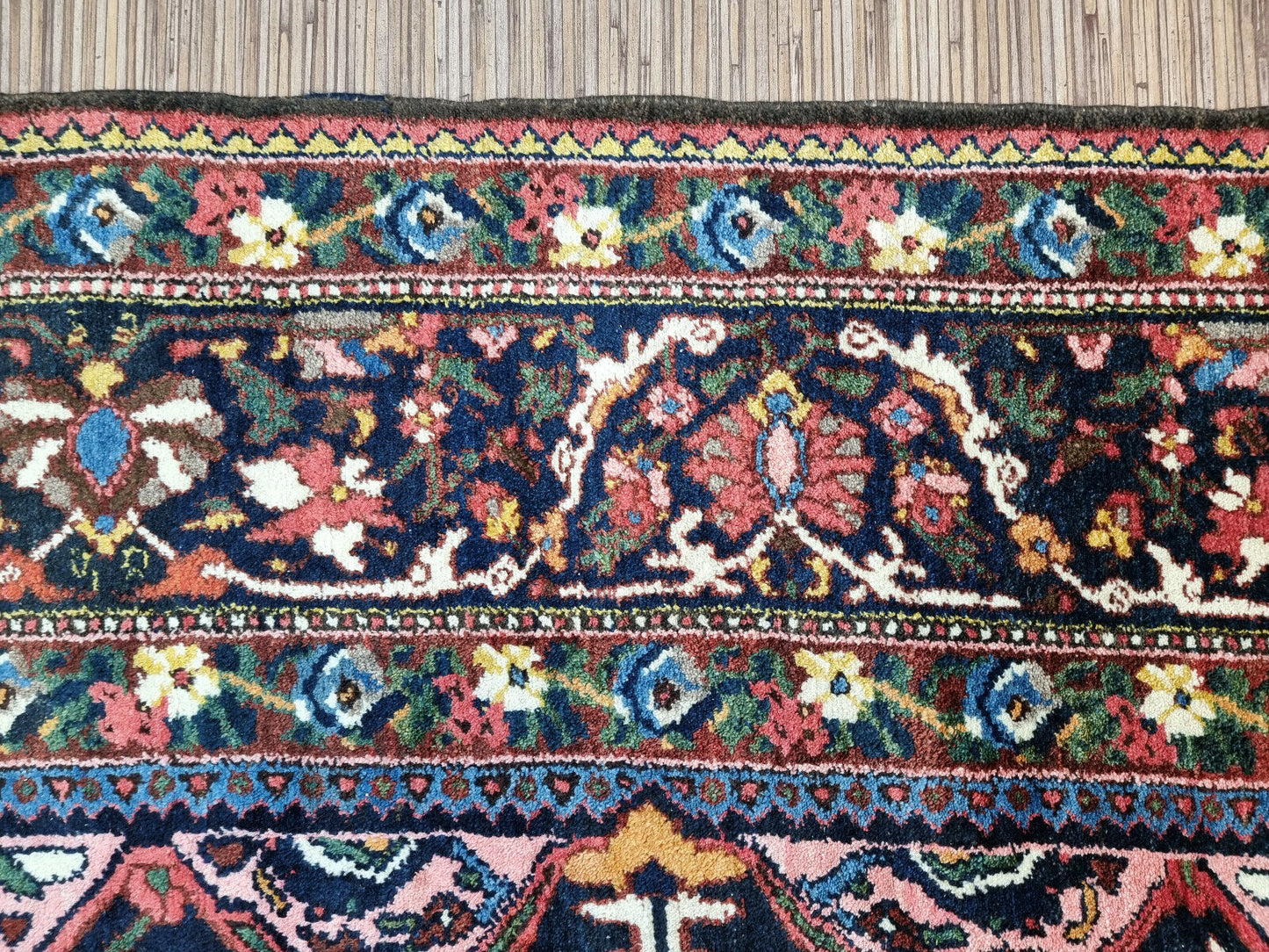 Close-up of geometric patterns on Handmade Antique Persian Bakhtiari Rug - Detailed view showcasing the geometric patterns that adorn the rug.