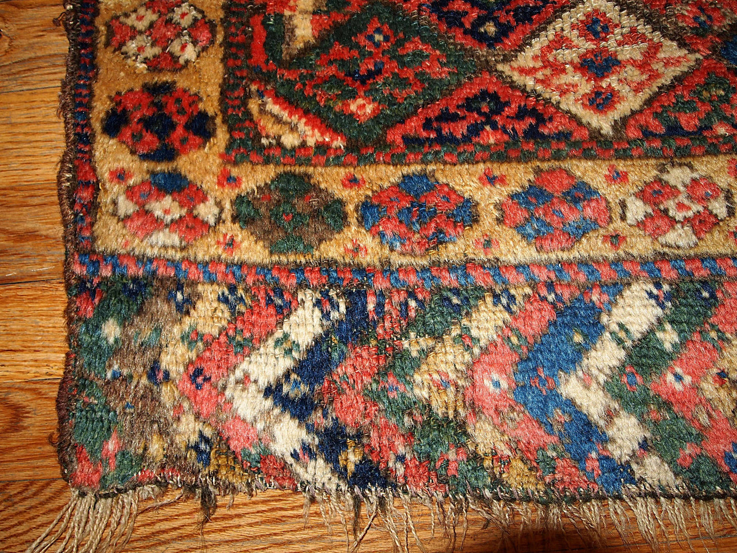 This square hand made antique collectible Persian Kurdish bag face in geometric design and in original good condition. Symmetric diamonds all around the field are in beige, blue, grey, cream and yellow colors.