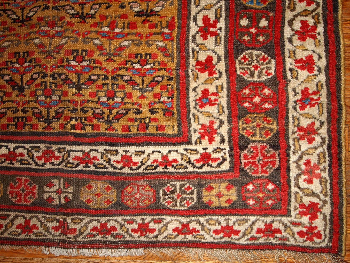 Antique Persian Kurdish rug in yellow, white and red colors. The rug is from the end of 19th century, in good condition.