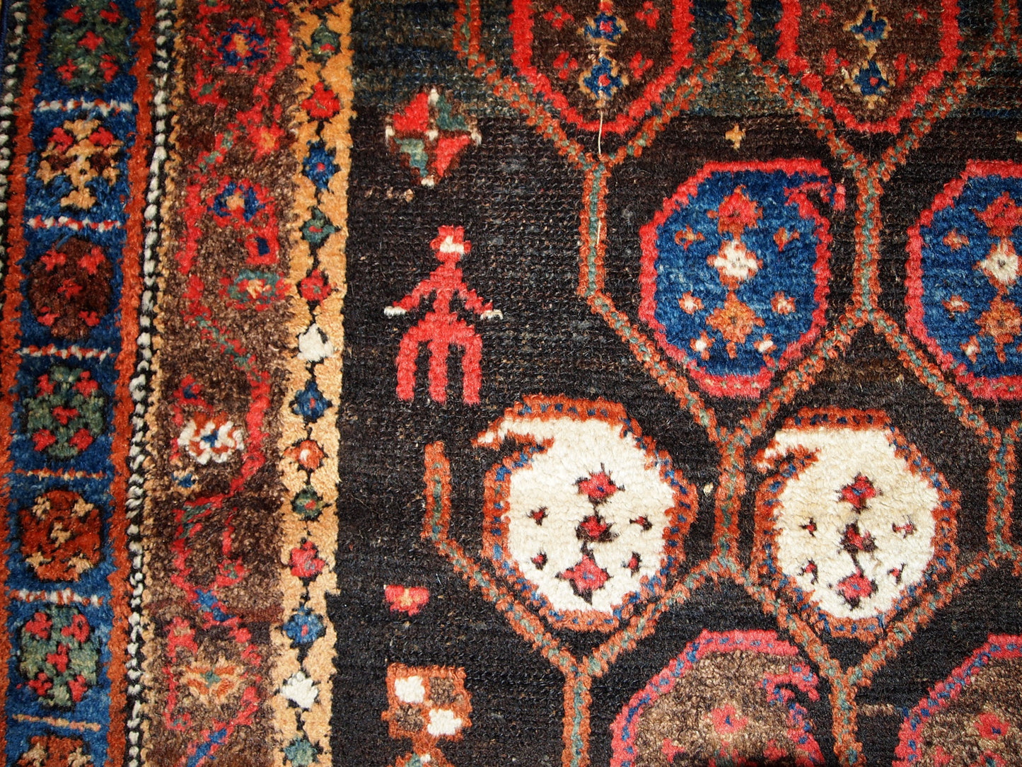 Antique Persian Kurdish rug in chocolate brown shade with repeating pattern. This rug is in original good condition.