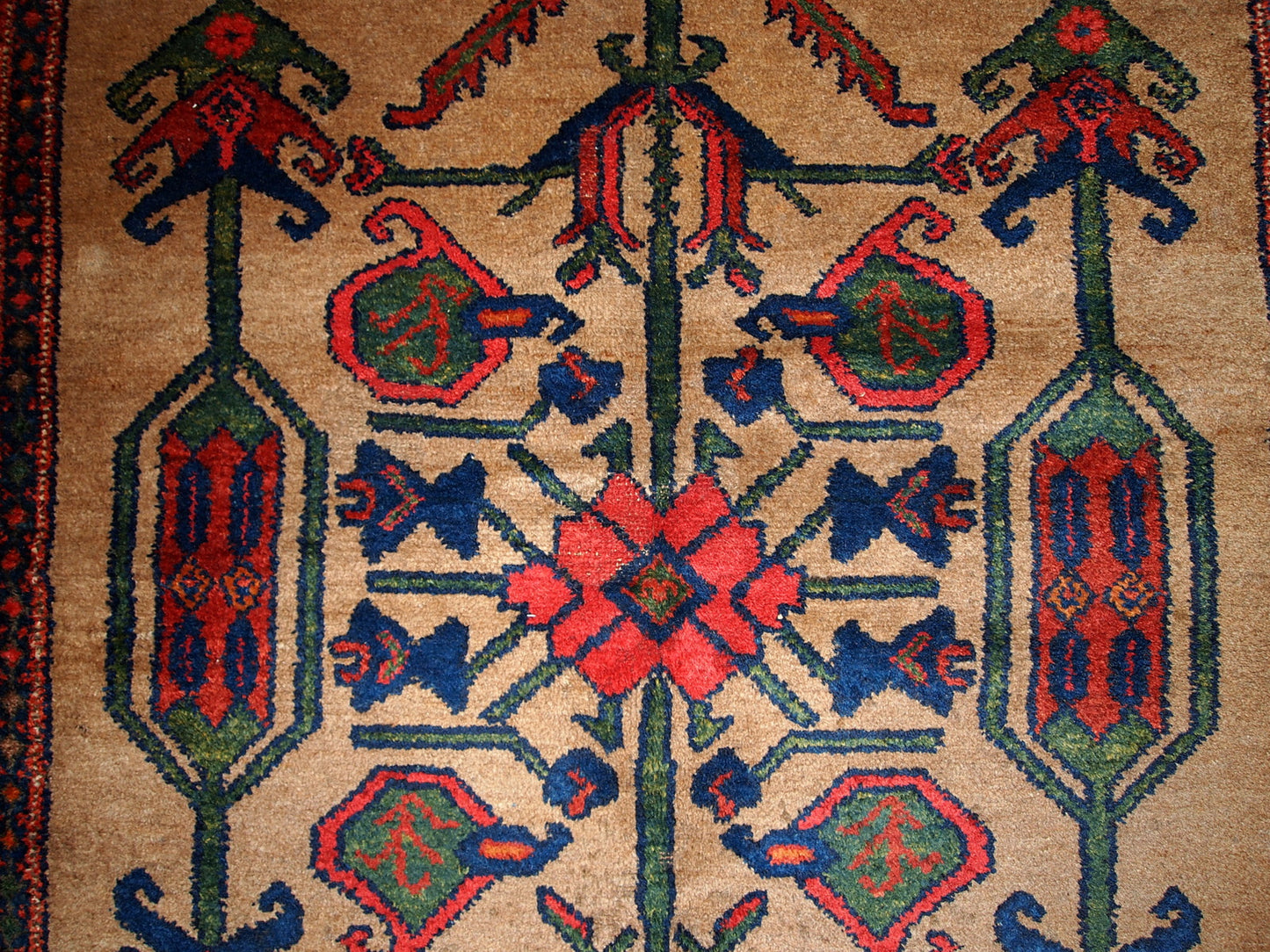 Antique Persian Kurdish rug in light brown background color. Very primitive tribal design with large ornaments. The rug is in original good condition.