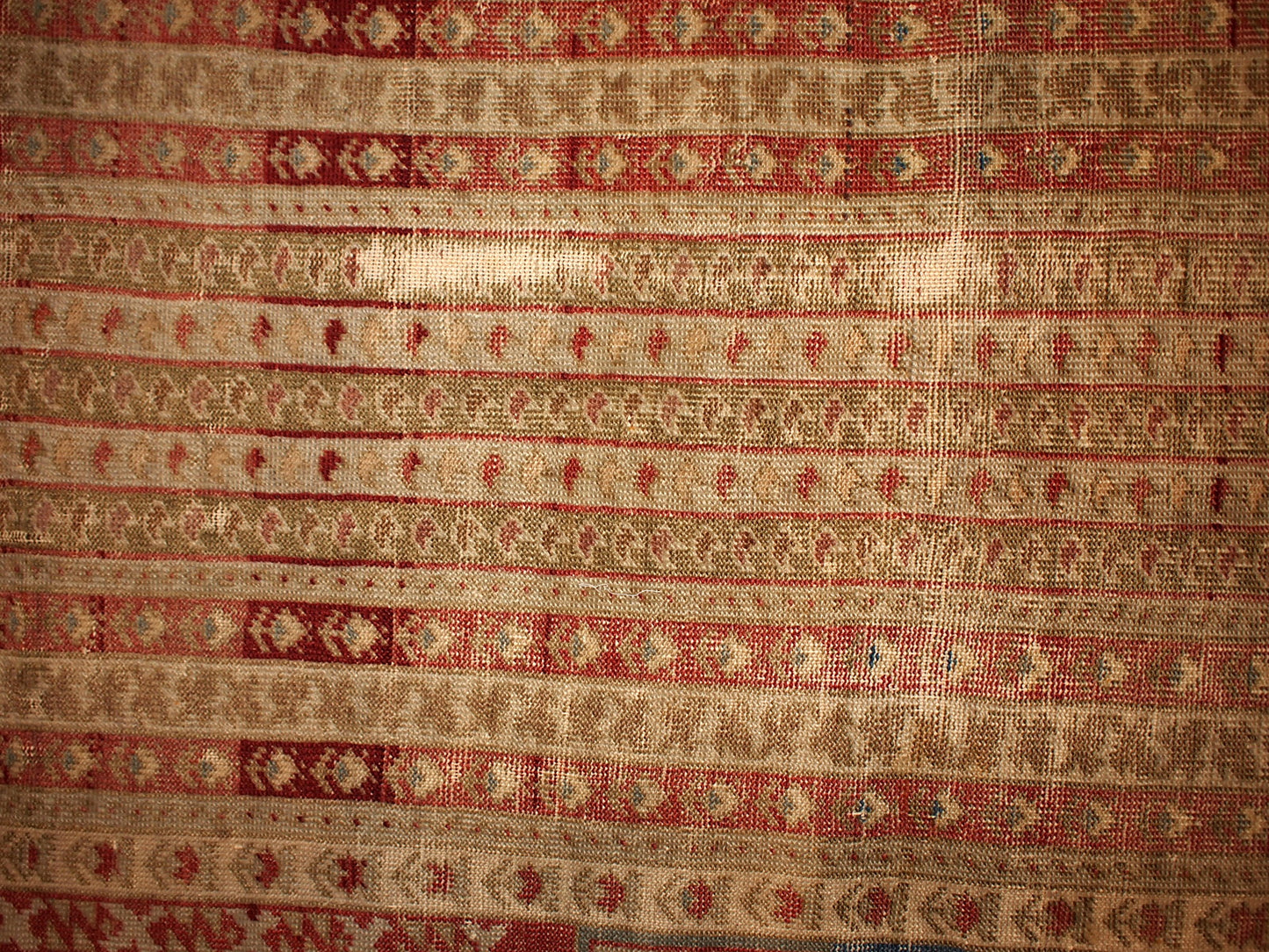 Antique collectible prayer Turkish Ghurdes rug in distressed condition. The rug is in olive green color and lots of narrow borders in burgundy, red and beige shades.