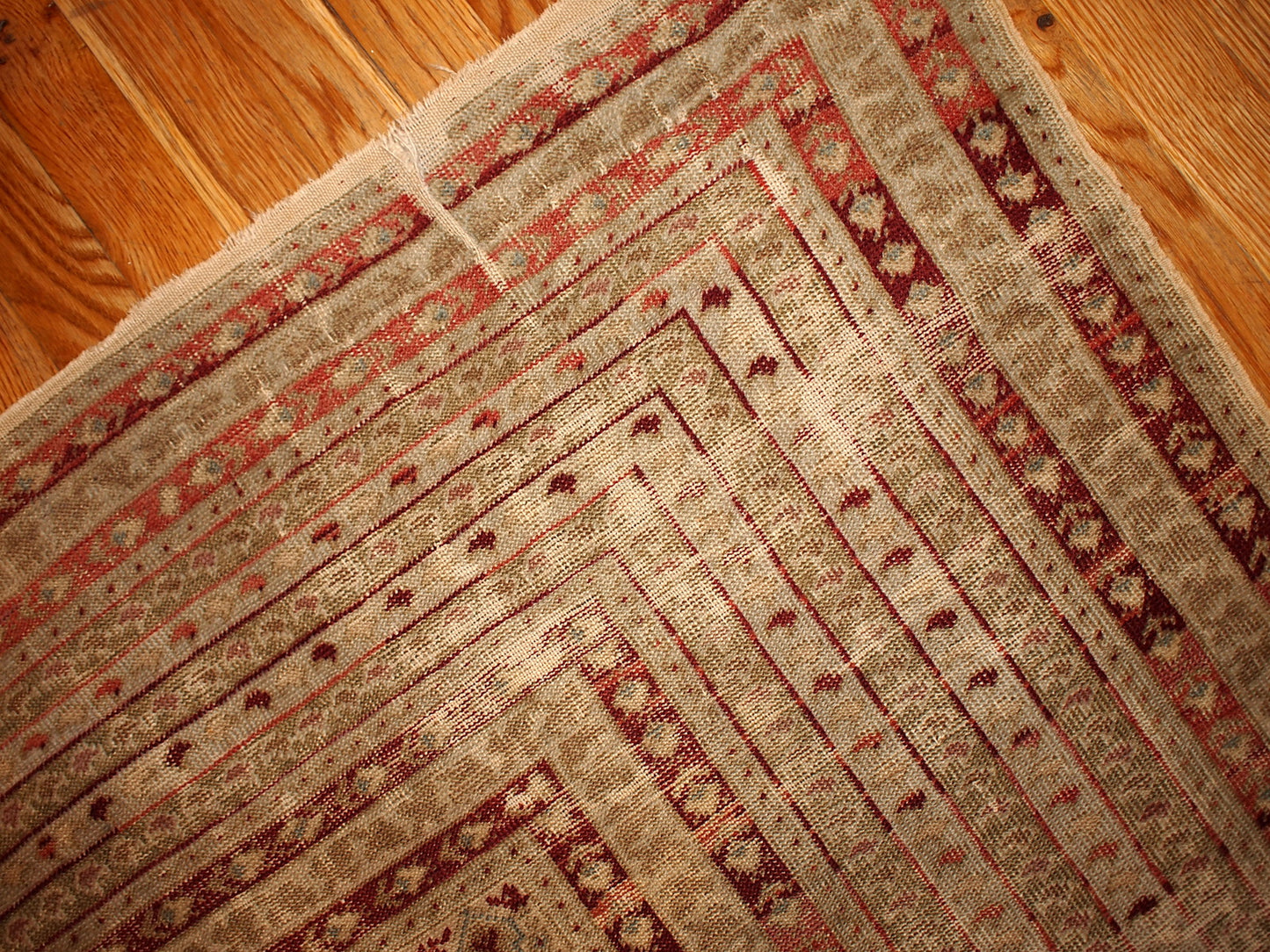 Antique collectible prayer Turkish Ghurdes rug in distressed condition. The rug is in olive green color and lots of narrow borders in burgundy, red and beige shades.