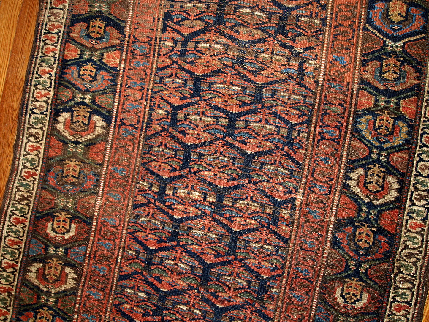 Antique hand made Persian Kurdish runner in navy blue and red shades. The rug is from the beginning of 20th century in original good condition.