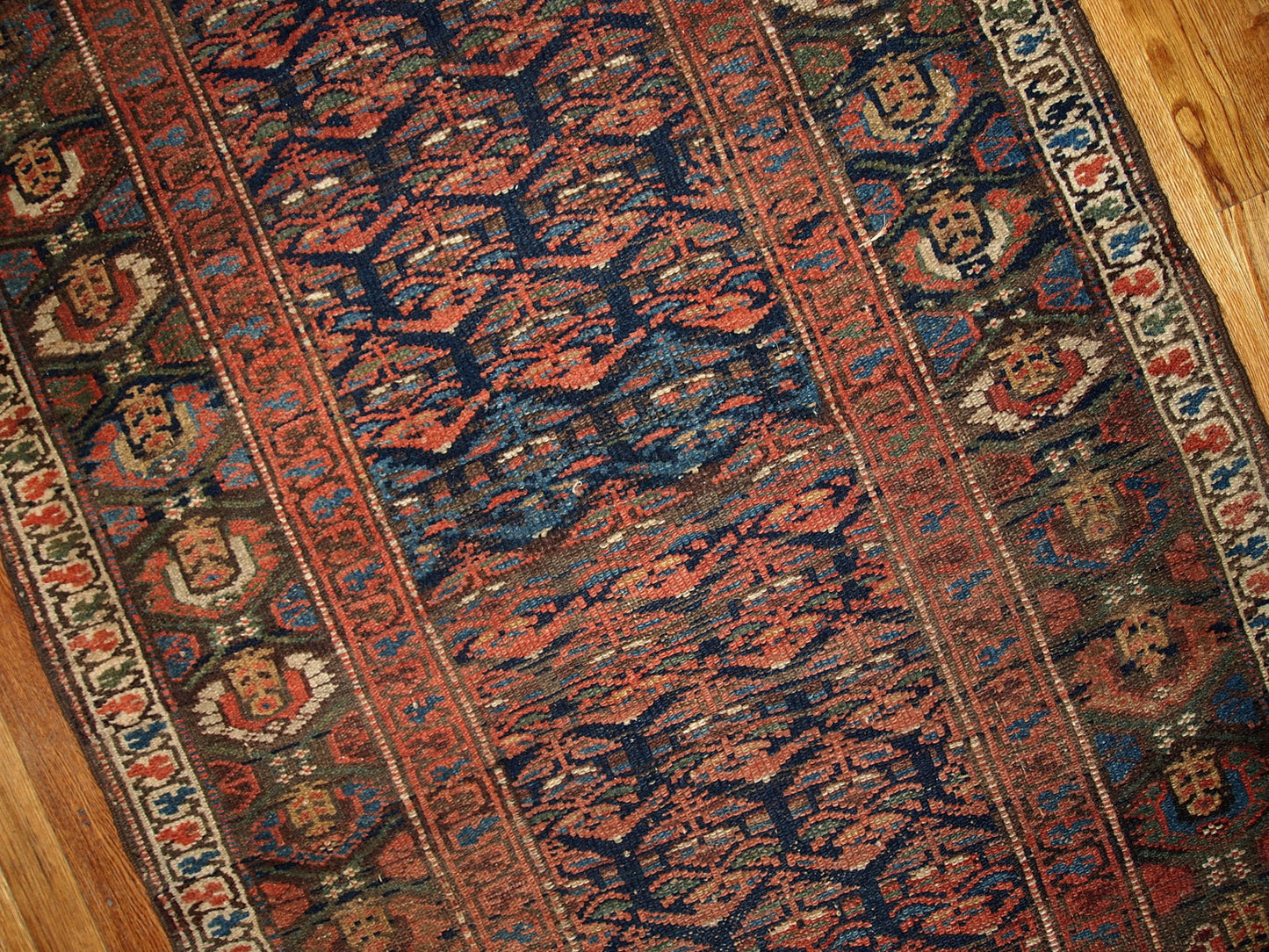 Antique hand made Persian Kurdish runner in navy blue and red shades. The rug is from the beginning of 20th century in original good condition.