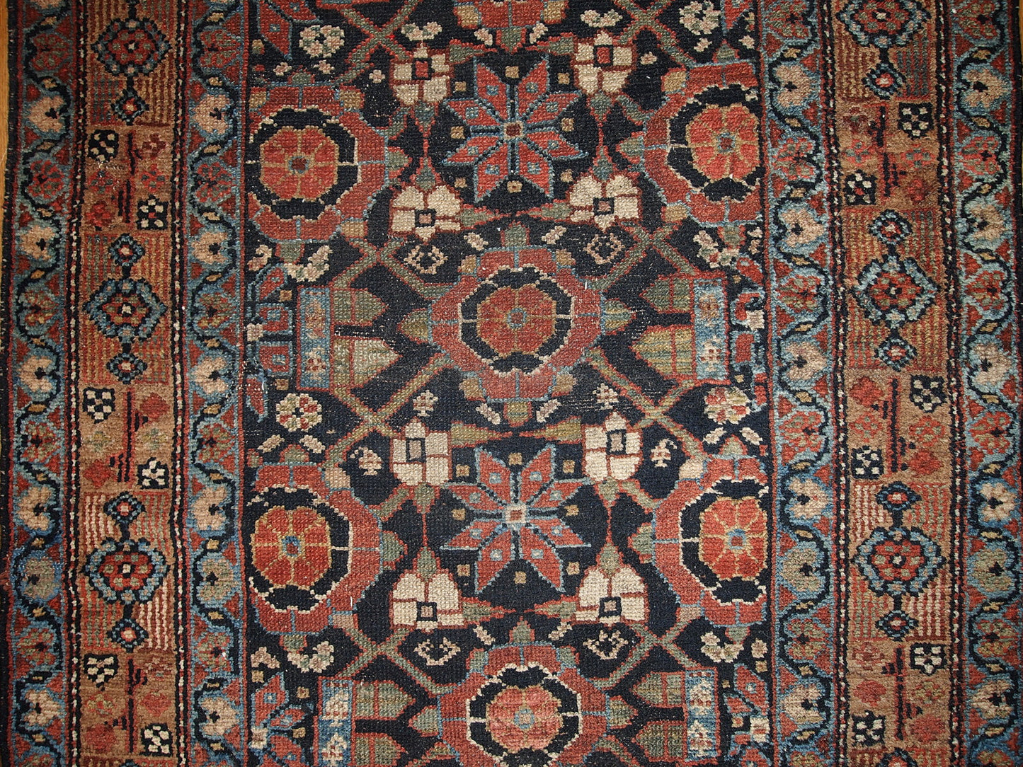 Antique Persian Hamadan runner in good original condition. This rug is in black and red shades.