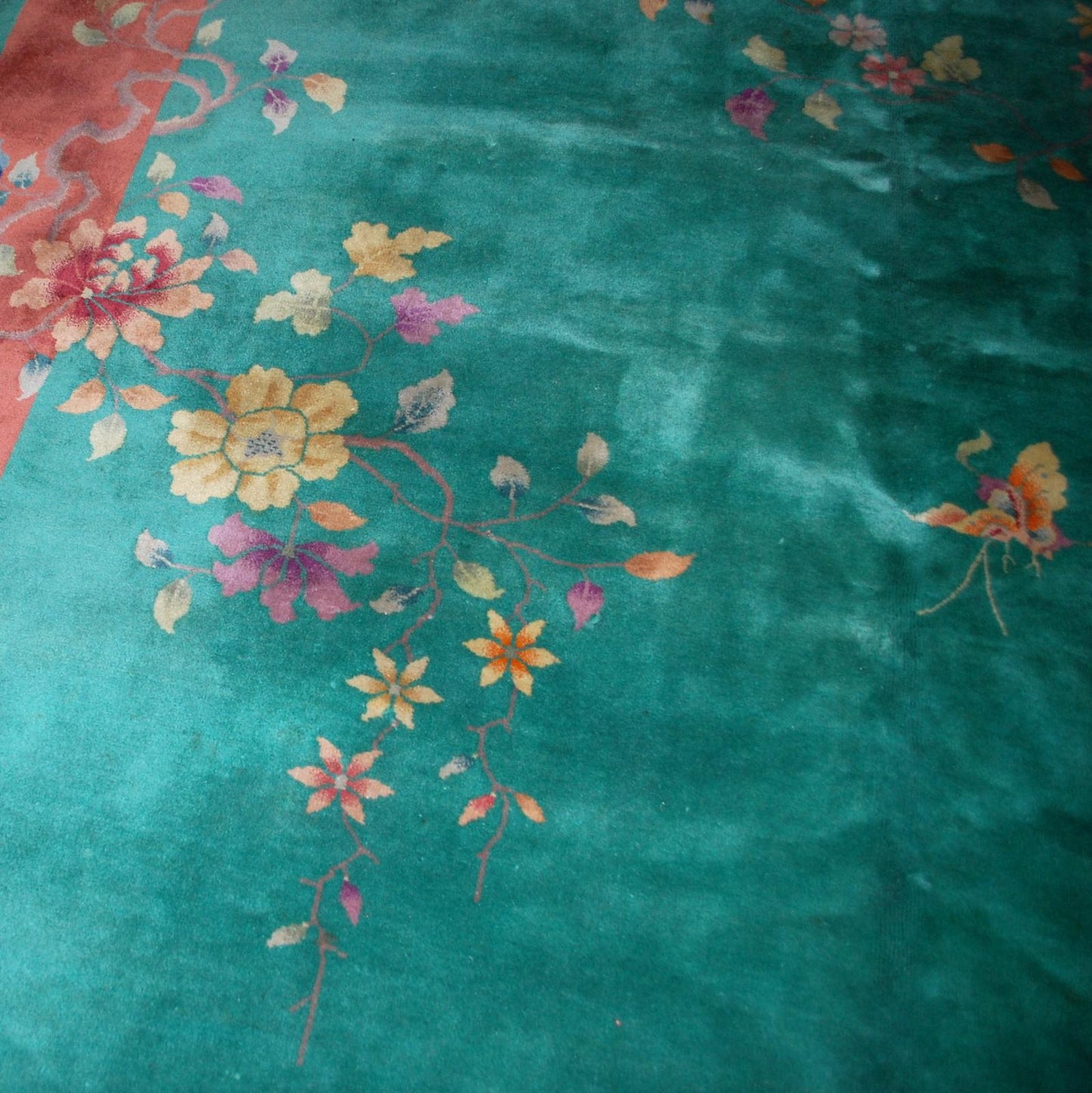 Handmade antique Art Deco Chinese rug in green and orange colors. The rug is from the beginning of 20th century in original good condition.