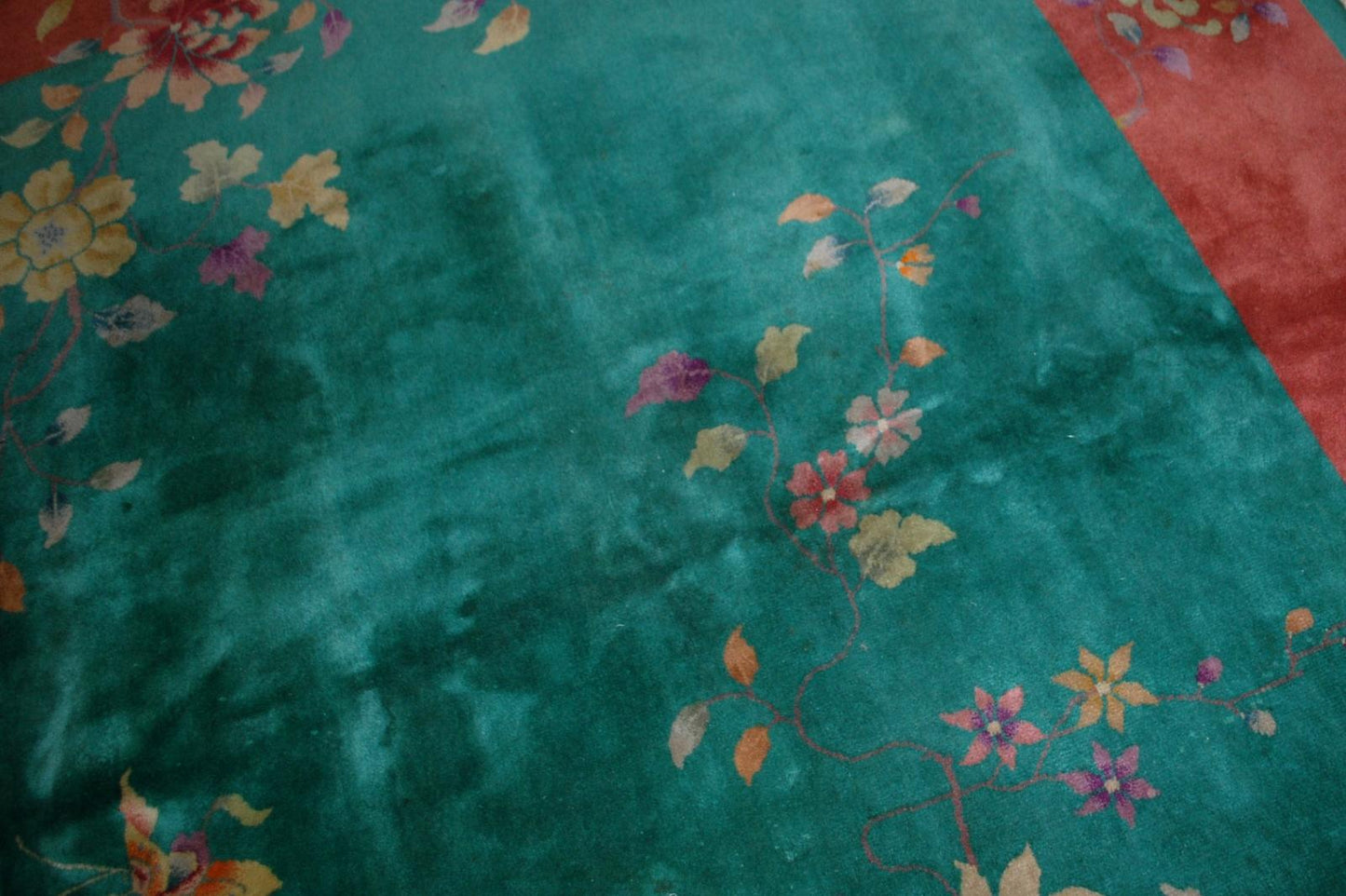 Handmade antique Art Deco Chinese rug in green and orange colors. The rug is from the beginning of 20th century in original good condition.