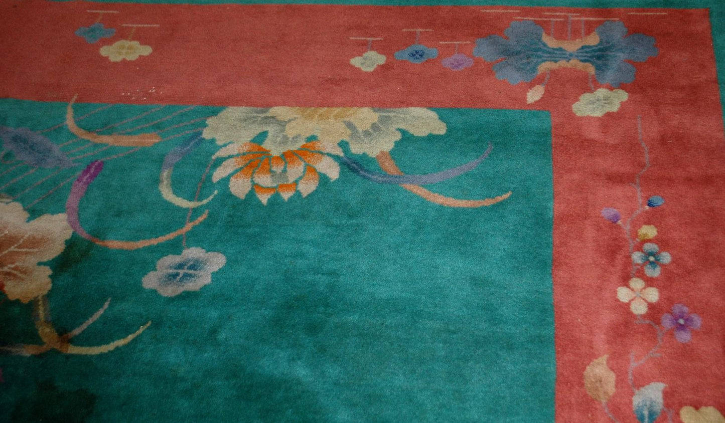 Handmade antique Art Deco Chinese rug in green and orange colors. The rug is from the beginning of 20th century in original good condition.