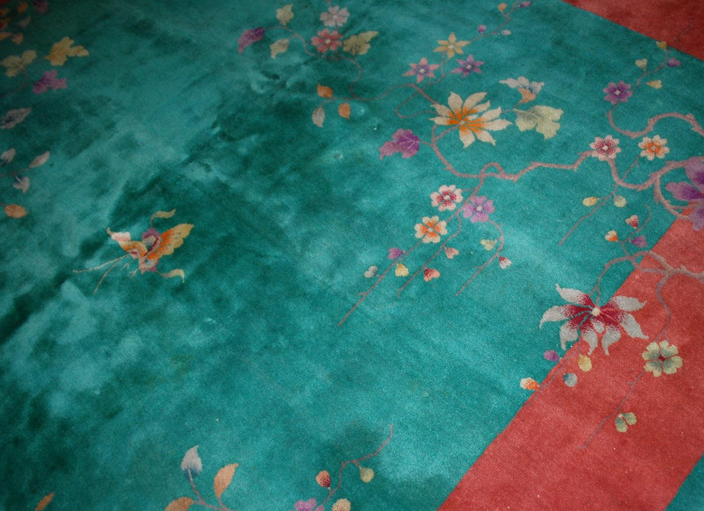 Handmade antique Art Deco Chinese rug in green and orange colors. The rug is from the beginning of 20th century in original good condition.