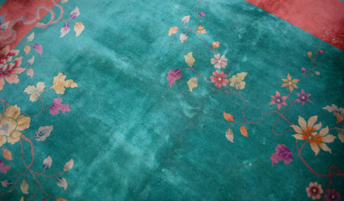 Handmade antique Art Deco Chinese rug in green and orange colors. The rug is from the beginning of 20th century in original good condition.