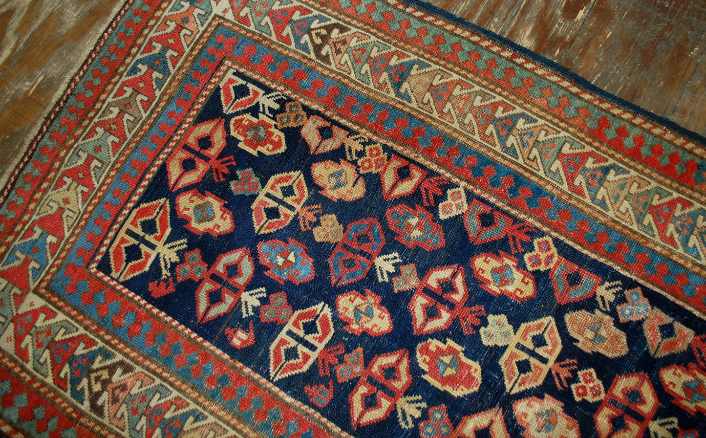 Antique handmade Caucasian Gendje rug in good condition. The rug has dark blue field covered in tribal figures, made in the end of 19th century.
