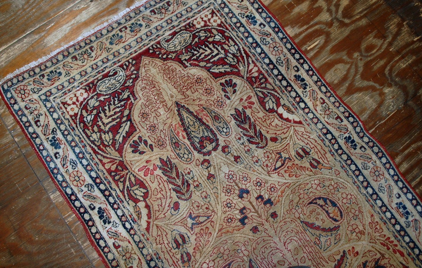 Persian Kerman Lavar rug in original condition, it has some low pile. The rug is prayer in beige and burgundy shades, made in the end of 19th century.