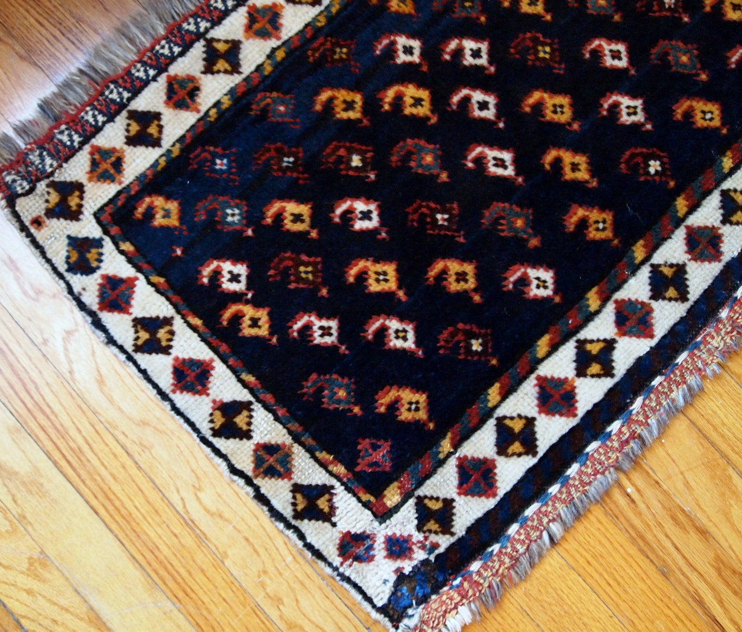 Antique collectible Persian Luri bagface in original good condition. Navy blue background with a slight abrash and colorful pattern in yellow, red and pink shades.