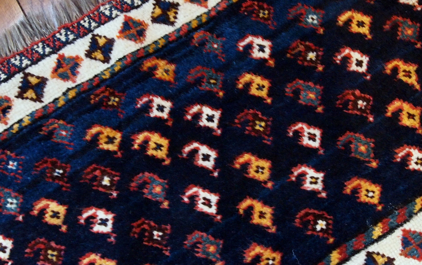 Antique collectible Persian Luri bagface in original good condition. Navy blue background with a slight abrash and colorful pattern in yellow, red and pink shades.