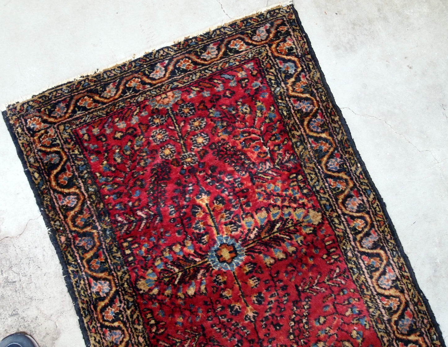 Antique handmade Persian Sarouk rug in red color with classic design. It is from the beginning of 20th century in original good condition.