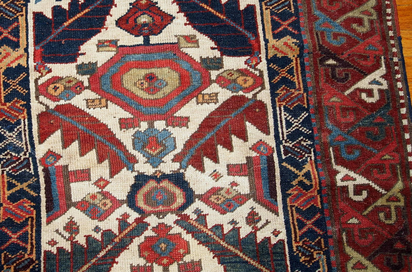 Hand made antique collectible Northwest Persian runner in original good condition. This rug is from the middle of 19th century in white, burgundy, blue and yellow shades.